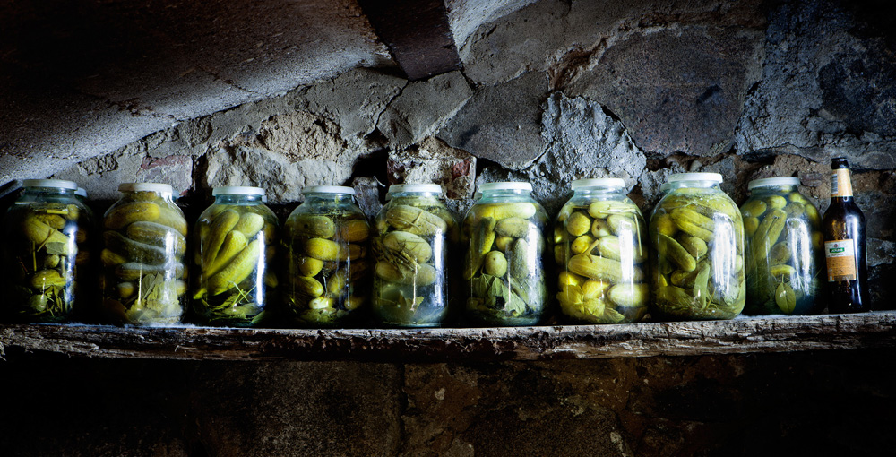 Jars of pickles on a shelf in a basement of a home near Skrunda.